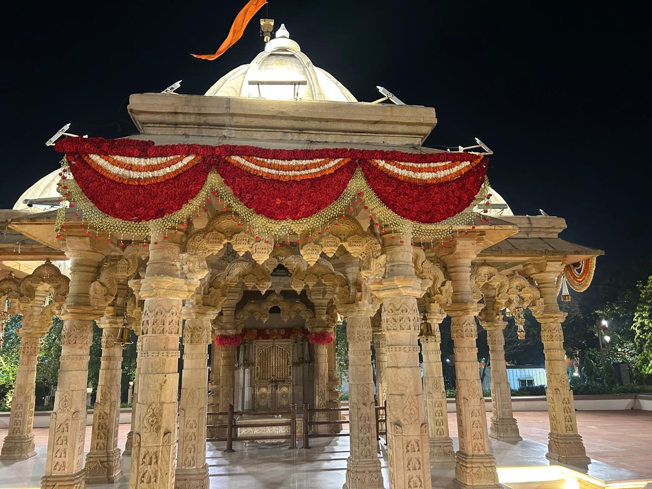 Ahana Raheja wedding at Vantara — marble temple night ceremony with red and marigold garlands