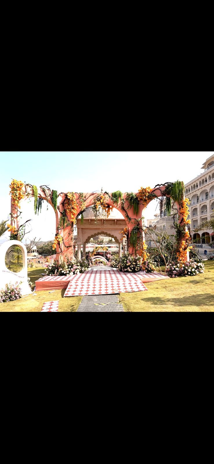 Bridgeton theme wedding at Le Méridien Jaipur — pink arch mandap with marigold and green draping