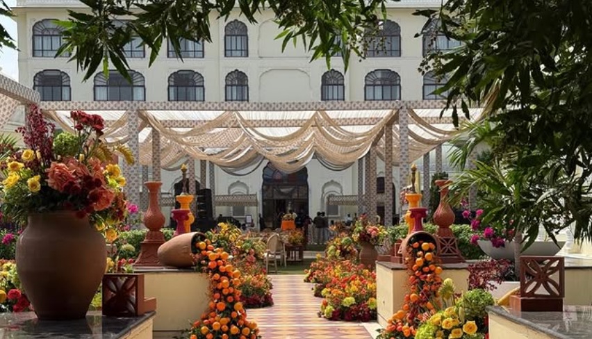 ITC Rajputana Jodhpur wedding — colorful marigold and rose-lined aisle with cloth canopy